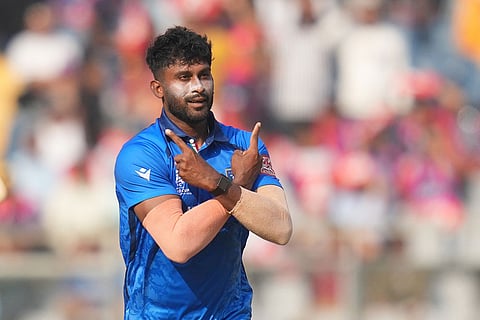 Italy's Crishan Kalugamage celebrates the wicket of Nepal's Gulshan Jha during the T20 World Cup cricket match between Italy and Nepal in Mumbai, India.