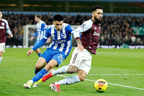 Aston Villa's Douglas Luiz, right, and Brighton's Diego Gomez battle for the ball during their English Premier League soccer match in Birmingham, England.