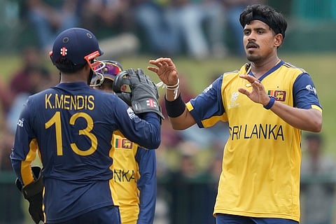 Sri Lanka's Maheesh Theekshana, right, celebrates with teammates the wicket of Oman's Wasim Ali during the T20 World Cup cricket match between Oman and Sri Lanka in Pallekele, Sri Lanka.