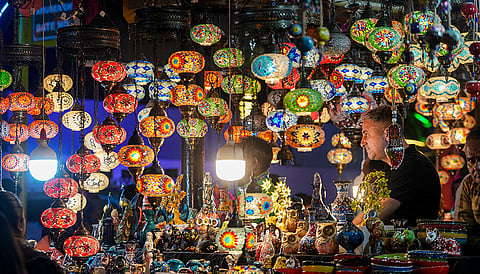 A turkish shopkeeper selling lamps, waits for customers in a stall during the '39th Surajkund Crafts Mela', in Faridabad, Haryana.