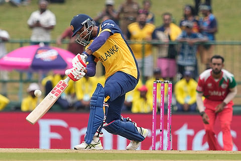 Sri Lanka's captain Dasun Shanaka plays a shot during the T20 World Cup cricket match between Oman and Sri Lanka in Pallekele, Sri Lanka.