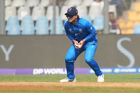 Italy's Anthony Mosca takes the catch to get dismiss Nepal's Kushal Bhurtel during the T20 World Cup cricket match between Italy and Nepal in Mumbai, India.