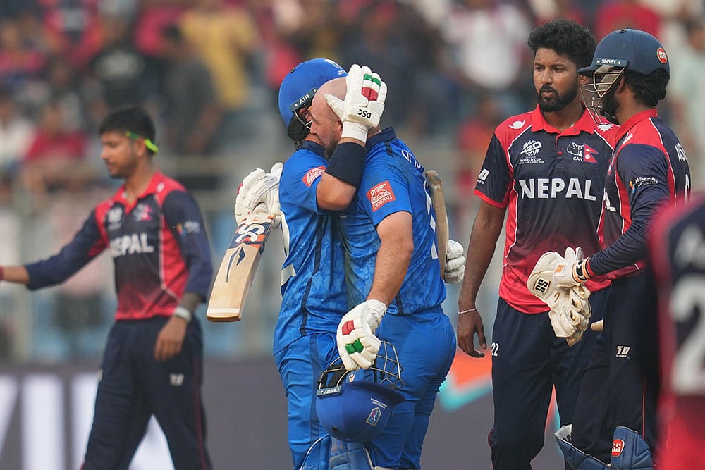Photo: AP/Rafiq Maqbool : Italy's Justin Mosca, left, Anthony Mosca celebrates after won the T20 World Cup cricket match against the Nepal in Mumbai, India.