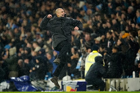 Manchester City's head coach Pep Guardiola celebrates after Manchester City's Erling Haaland scoring his side's third goal during the English Premier League soccer match between Manchester City and Fulham in Manchester, England.