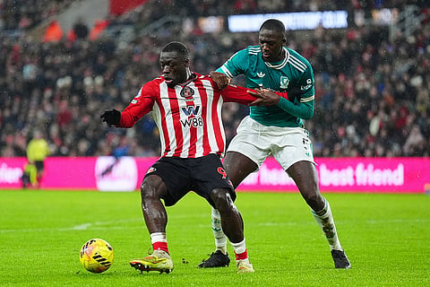 Sunderland's Brian Brobbey, left, and Liverpool's Ibrahima Konate battle for the ball during their English Premier League soccer match, in Sunderland, England.