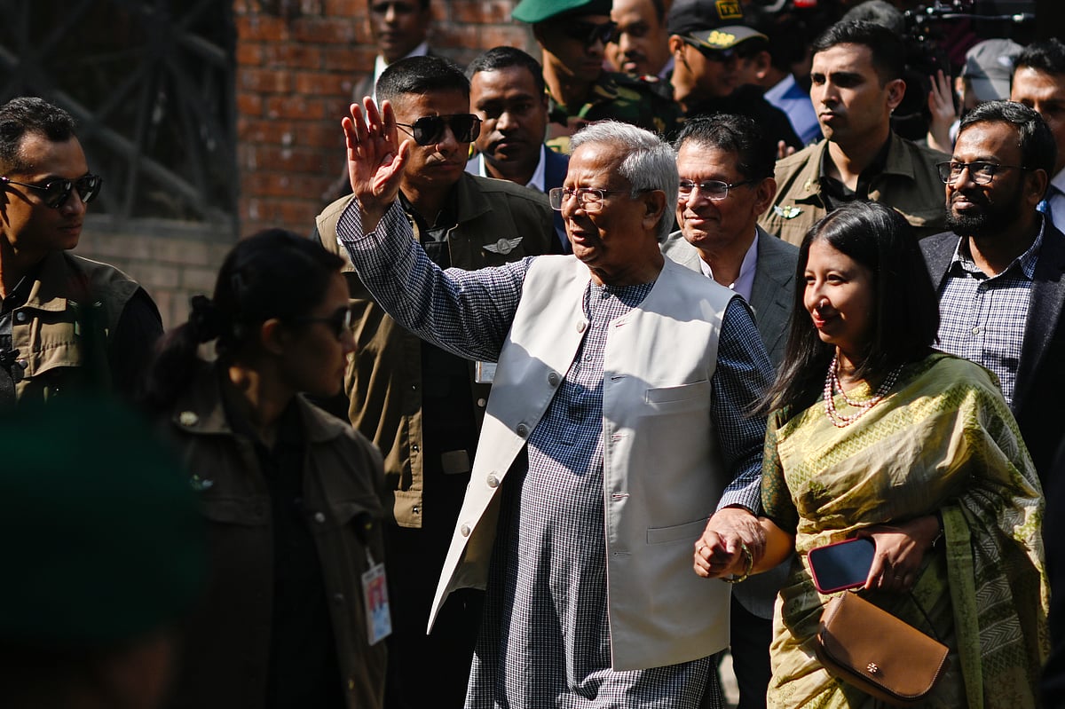 Mahmud Hossain Opu/ AP : Chief Adviser of Bangladesh Muhammad Yunus, center, waves after casting his vote as he comes out of a polling center during the national parliamentary elections in Dhaka, Bangladesh, Thursday, Feb. 12, 2026.