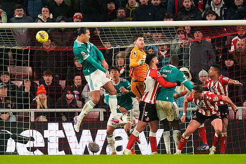 Liverpool's Virgil van Dijk scores their side's first goal of the game during the English Premier League soccer match against Sunderland, in Sunderland, England.