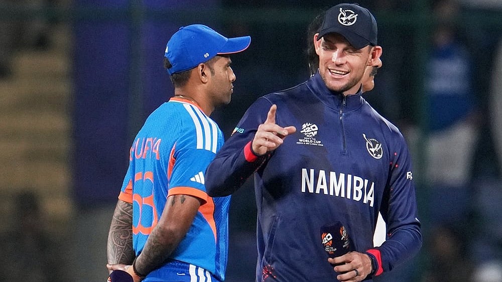 | Photo: AP/Manish Swarup : Namibia's captain Gerhard Erasmus, right, and India's captain Suryakumar Yadav chat before the coin toss of the T20 World Cup cricket match between India and Namibia in New Delhi.