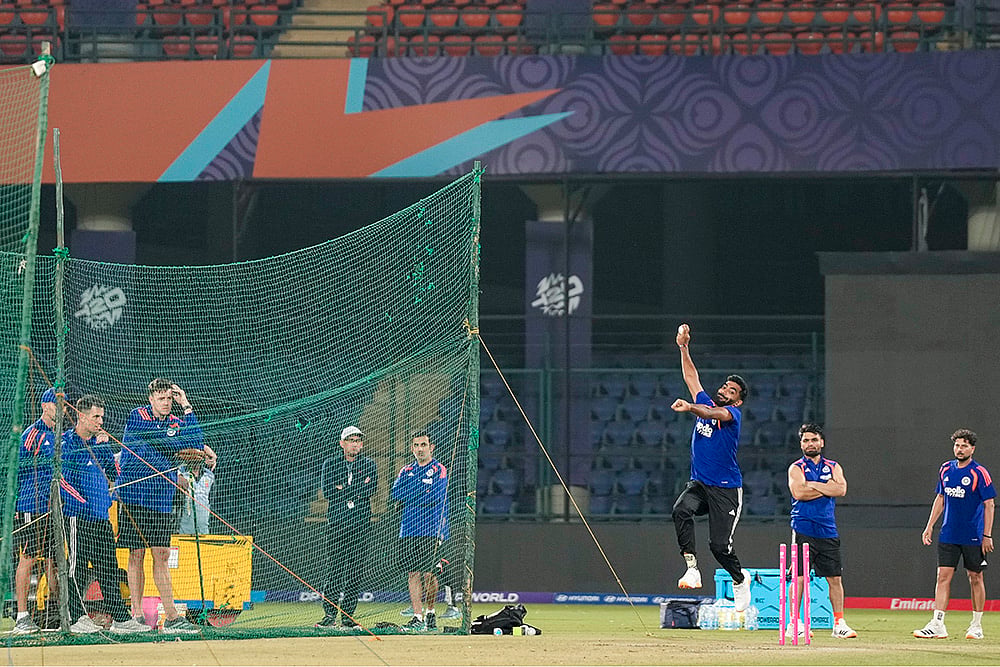 | Photo: PTI/Salman Ali : India's Jasprit Bumrah bowls a delivery during a practice session ahead of an ICC Men's T20 World Cup 2026 cricket match between India and Namibia, at the Arun Jaitley Stadium, in New Delhi. BCCI selection committee Chairman Ajit Agarkar, the team’s head coach Gautam Gambhir, bowling coach Morne Morkel and players Rinku Singh and Kuldeep Yadav are also seen.