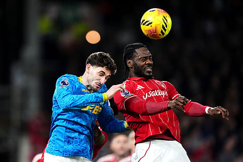 Nottingham Forest's Ola Aina, right, battle for the ball with Wolverhampton Wanderers' Santiago Bueno during the English Premier League soccer match between Nottingham Forest and Wolverhampton Wanderers, in Nottingham, England.