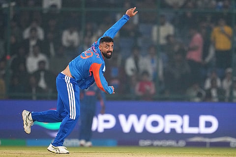 India's Varun Chakravarthy bowls a delivery during the T20 World Cup cricket match between India and Namibia in New Delhi.