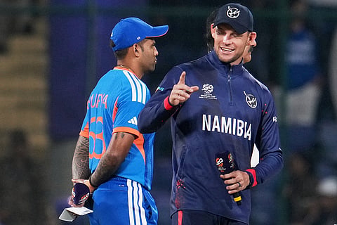 Namibia's captain Gerhard Erasmus, right, and India's captain Suryakumar Yadav chat before the coin toss of the T20 World Cup cricket match between India and Namibia in New Delhi.