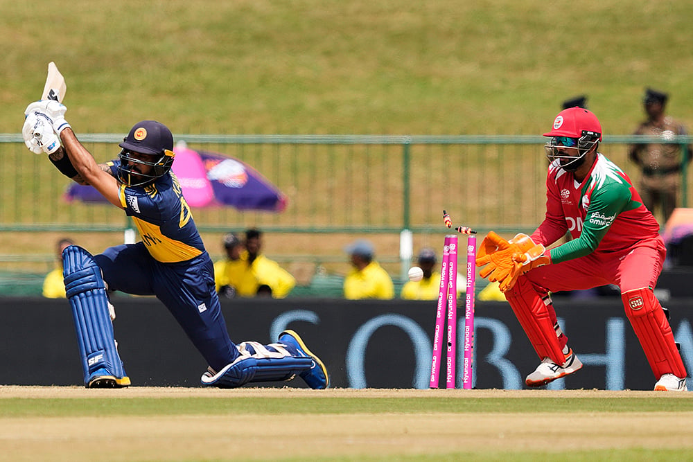 | Photo: AP/Eranga Jayawardena : Sri Lanka's Kamil Mishara bowled out by Oman's Jay Odedra during the T20 World Cup cricket match between Oman and Sri Lanka in Pallekele, Sri Lanka.