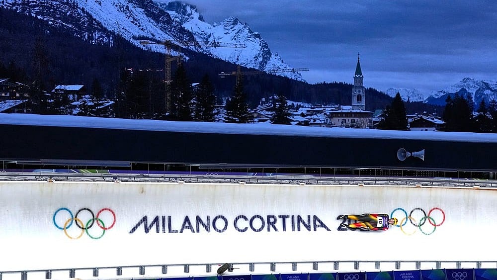 Photo: AP/Alessandra Tarantino : Germany's Anna Berreiter slides down the track during a women's single luge run at the 2026 Winter Olympics, in Cortina d'Ampezzo, Italy.
