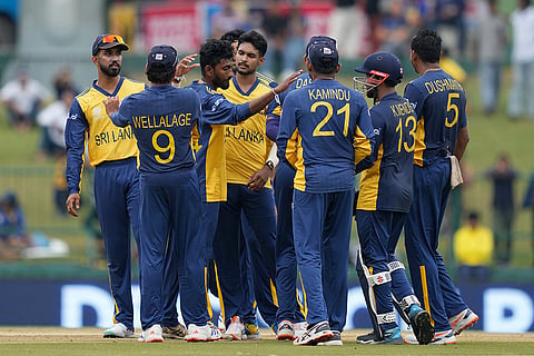 Sri Lanka's Dushan Hemantha, third left, celebrates with teammates the wicket of Oman's Jiten Ramanandi during the T20 World Cup cricket match between Oman and Sri Lanka in Pallekele, Sri Lanka.