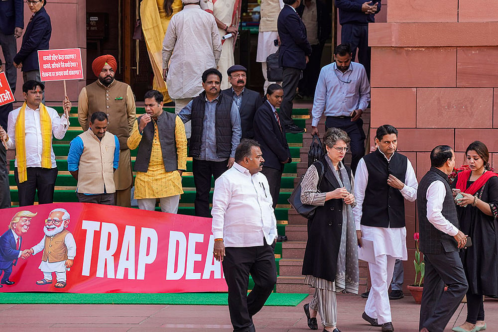 | Photo: PTI/Salman Ali : Congress MP Priyanka Gandhi Vadra, suspended MPs Hibi Eden, Dean Kuriakose, Prashant Padole, Manickam Tagore and other opposition MPs stage a protest over the India-US interim trade deal, accusing the government of "surrendering" Indian interests, during the Budget session of Parliament, in New Delhi.