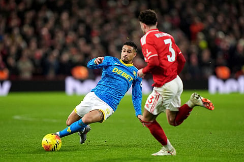 Wolverhampton Wanderers' Joao Gomes, left, battles for the ball with Nottingham Forest's Neco Williams during their English Premier League soccer match in Nottingham, England.
