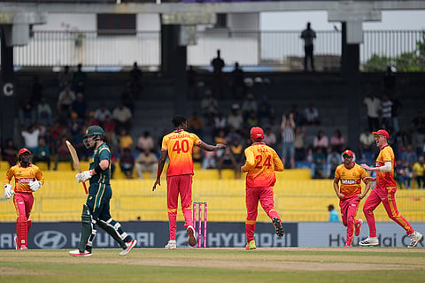 Zimbabwe's Blessing Muzarabani, center, celebrates with teammates the wicket of Australia's Josh Inglis, second left, during the T20 World Cup cricket match between Australia and Zimbabwe in Colombo, Sri Lanka.