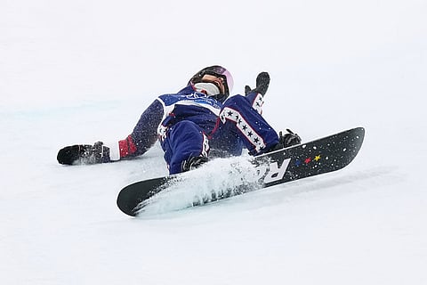 United States' Chloe Kim falls during the women's snowboarding halfpipe finals at the 2026 Winter Olympics, in Livigno, Italy.