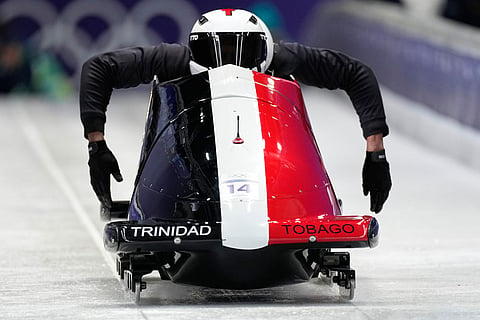 Trinidad And Tobago's Axel Brown, front, starts for a two man bobsled training session at the 2026 Winter Olympics, in Cortina d'Ampezzo, Italy.