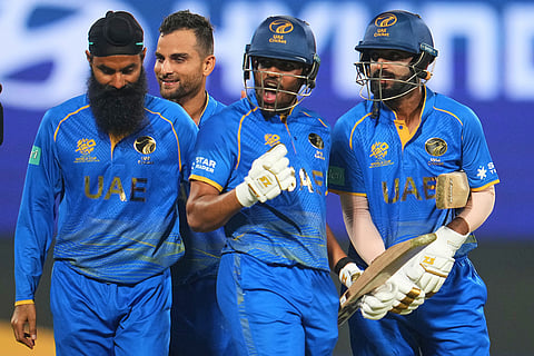 United Arab Emirates' Aryansh Sharma, center, with teammates celebrate after defeating Canada during the T20 World Cup cricket match in New Delhi.