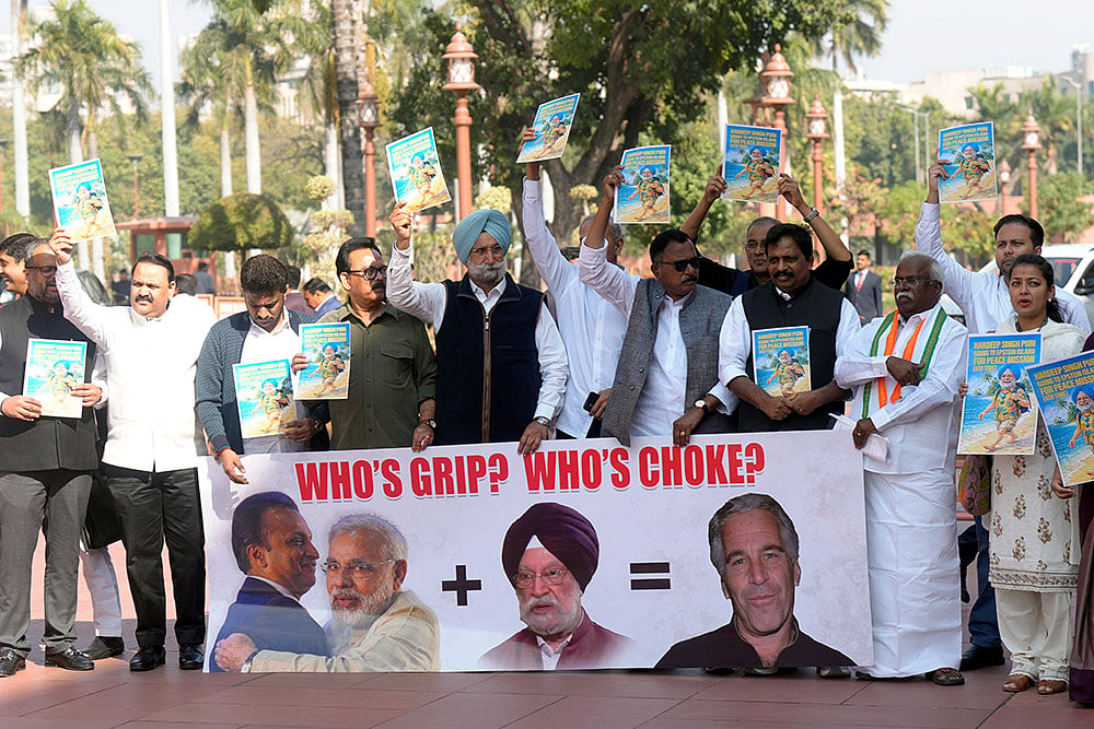 | Photo: Shahbaz Khan/PTI  : Congress MP Sukhjinder Singh Randhawa and other Opposition MPs stage a protest during the Budget session of Parliament, in New Delhi.