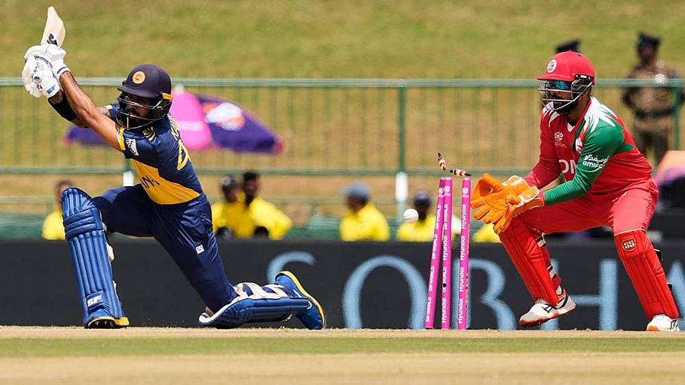 | Photo: AP/Eranga Jayawardena : Sri Lanka's Kamil Mishara bowled out by Oman's Jay Odedra during the T20 World Cup cricket match between Oman and Sri Lanka in Pallekele, Sri Lanka.