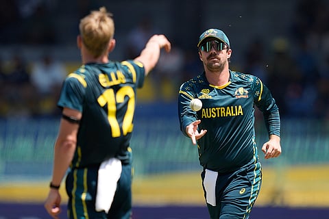 Australia's captain Travis Head, right, throws a ball during the T20 World Cup cricket match between Australia and Zimbabwe in Colombo, Sri Lanka.