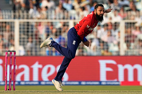 England's Adil Rashid bowls a delivery during the T20 World Cup cricket match between England and Scotland in Kolkata, India.