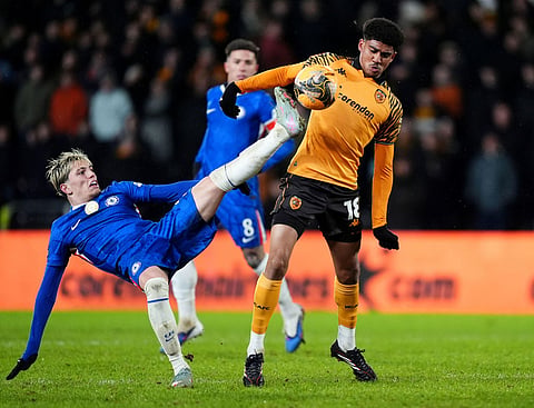 Chelsea's Alejandro Garnacho, left, and Hull City's Cody Drameh battle for the ball during the English FA Cup fourth round soccer match between Hull City and Chelsea in Hull, England.