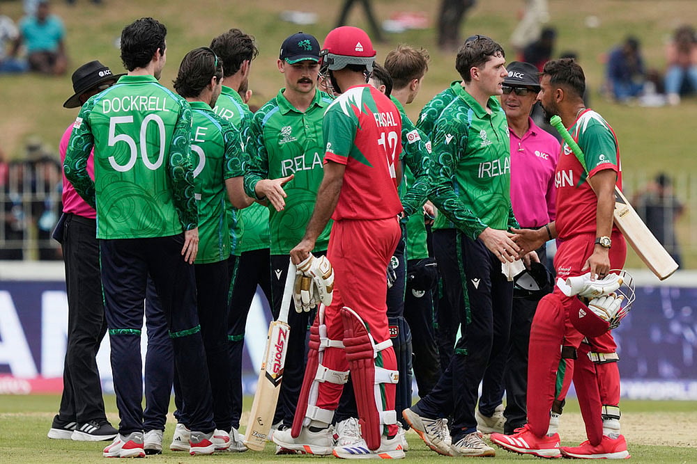 | Photo: AP/Eranga Jayawardena : Ireland's players shake hands with Oman's players after they won the T20 World Cup cricket match against Oman in Colombo, Sri Lanka.