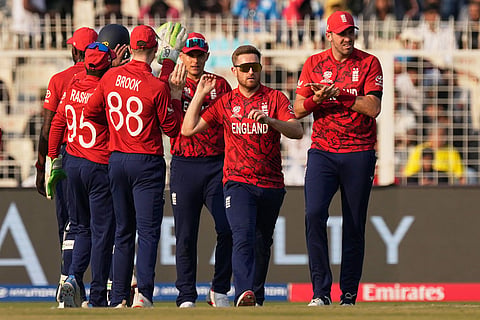 England's Liam Dawson, second right, celebrates with teammates the wicket of Scotland's Tom Bruce during the T20 World Cup cricket match between England and Scotland in Kolkata, India.