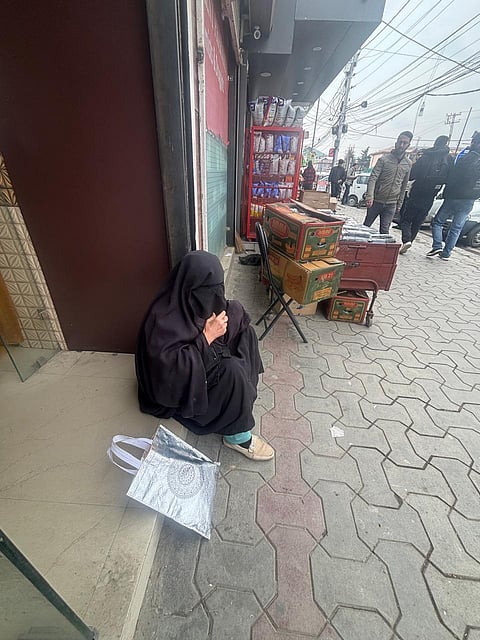 Away from the crowds and chatter, Shamima rests with a black burka drawn close around her shoulders.