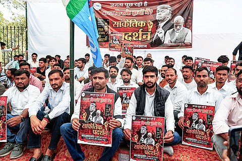 National Students' Union of India’s (NSUI) Rajasthan President Vinod Jakhar, third right, and others stage a dharna during a symbolic protest over the alleged 'Epstein Files' row and against Prime Minister Narendra Modi, at Shaheed Smarak, in Jaipur.