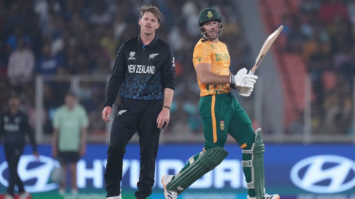 AP Photo : South Africa's captain Aiden Markram, right, run between the wickets as New Zealand's Lockie Ferguson reacts during the T20 World Cup cricket match between South Africa and New Zealand in Ahmedabad.