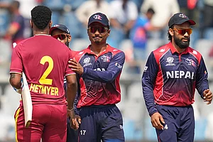 | Photo: AP/Rafiq Maqbool : West Indies' Shimron Hetmyer, left shake hand with Nepal's captain Rohit Paudel at the end of the play during the T20 World Cup cricket match between Nepal and West Indies in Mumbai.