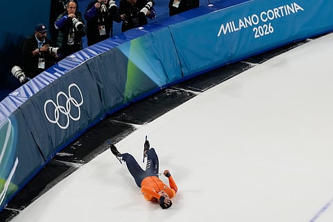 Netherlands' Jenning de Boo lies on the ice after falling while finishing second in the men's 500-meters speedskating final at the 2026 Winter Olympics, in Milan, Italy.