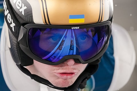 Yevhen Marusiak, of Ukraine, goes down the ramp during his trial jump of the ski jumping men's large hill individual at the 2026 Winter Olympics, in Predazzo, Italy.