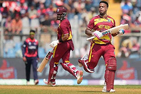 West Indies' Shimron Hetmyer, right and captain Shai Hope run between the wickets to score during the T20 World Cup cricket match between Nepal and West Indies in Mumbai.