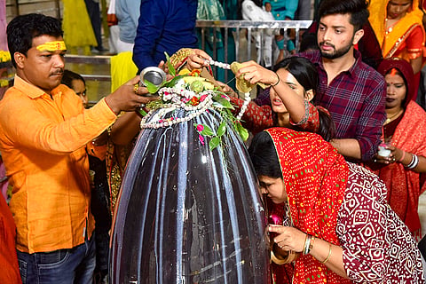 People offer prayers at Mani Temple on the occasion of 'Maha Shivaratri', in Varanasi.