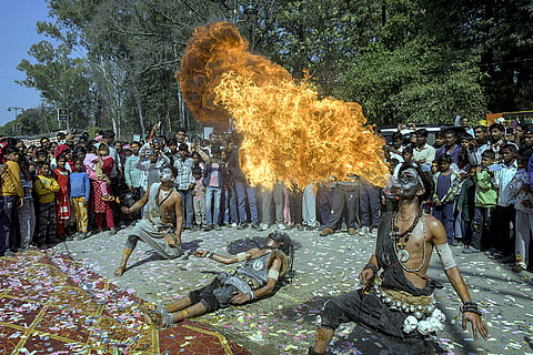 Artistes perform with fire during an event on the occasion of 'Maha Shivratri' festival, in Dehradun, Uttarakhand.