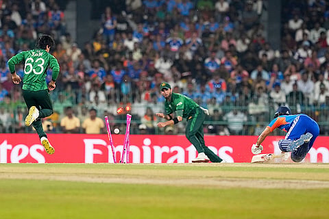 India's Ishan Kishan, right, dives to make his crease safely as a throw from Pakistan's Saim Ayub, left, breaks the stumps during the T20 World Cup cricket match between India and Pakistan in Colombo, Sri Lanka.