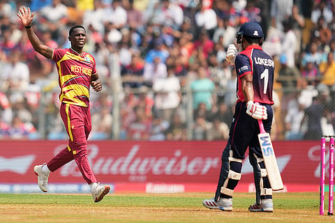 West Indies' Shamar Joseph celebrates the wicket of Nepal's Lokesh Bam, right during the T20 World Cup cricket match between Nepal and West Indies in Mumbai.