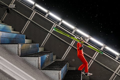 Gregor Deschwanden, of Switzerland, walks at the ramp for his trial jump of the ski jumping men's large hill individual at the 2026 Winter Olympics, in Predazzo, Italy.