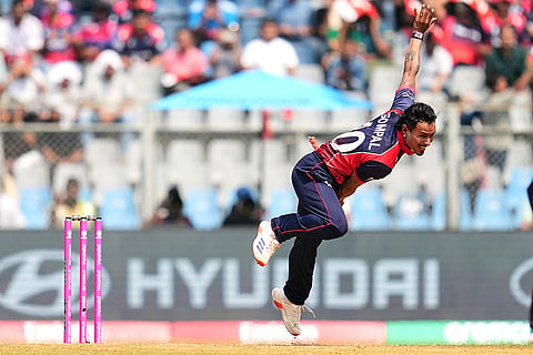 Nepal's Sompal Kami bowls a delivery during the T20 World Cup cricket match between Nepal and West Indies in Mumbai.
