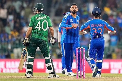 India's Varun Chakravarthy, center, celebrates the wicket of Pakistan's Abrar Ahmed, left, during the T20 World Cup cricket match between India and Pakistan in Colombo, Sri Lanka.