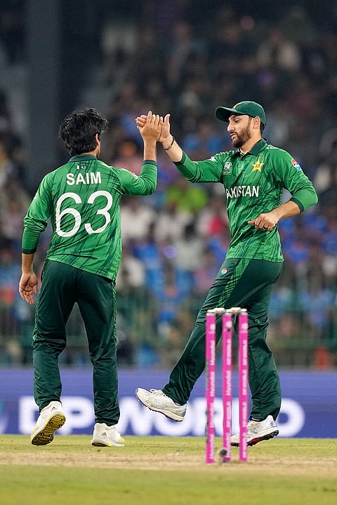 Pakistan's Saim Ayub, left, and captain Salman Ali Agha celebrate the wicket of India's Ishan Kishan during the T20 World Cup cricket match between India and Pakistan in Colombo, Sri Lanka.
