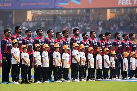 Nepal players stand up for the national anthems before the start of the match during the T20 World Cup cricket match between Nepal and West Indies in Mumbai.