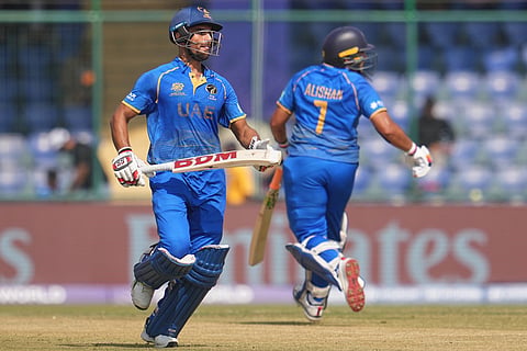 United Arab Emirates' Sohaib Khan, left, and United Arab Emirates' Alishan Sharafu run between the wickets to score during the T20 World Cup cricket match between Afghanistan and United Arab Emirates in New Delhi.