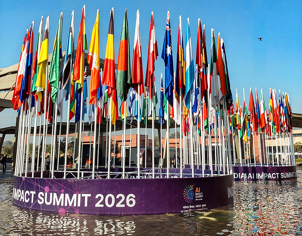 | Photo: PTI : National flags of various countries at Bharat Mandapam during the India AI Impact Summit 2026, in New Delhi.